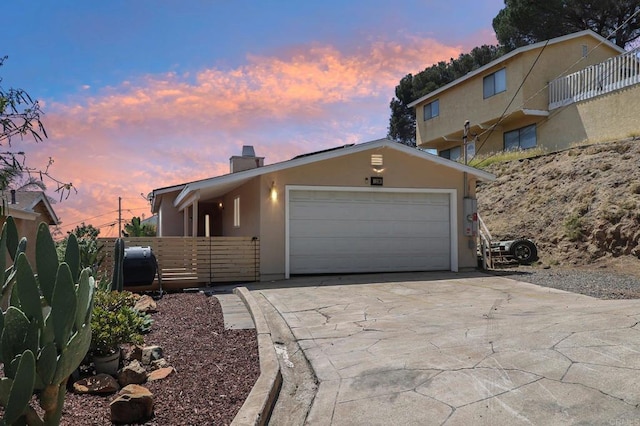 1230 Ramona Ave, Spring Valley, CA 91977 - view of front of home with a chimney, concrete driveway, stucco siding, and an attached garage