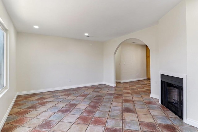 1230 Ramona Ave, Spring Valley, CA 91977 - unfurnished living room with arched walkways, a fireplace, and recessed lighting