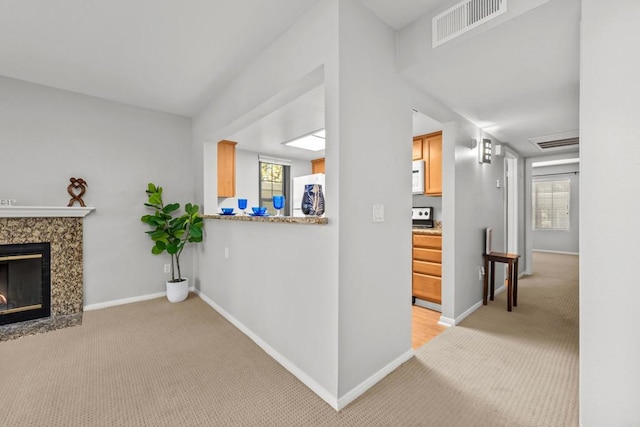 15032 Avenida Venusto Unit 179, San Diego, CA 92128 - unfurnished living room with light carpet, plenty of natural light, and a premium fireplace