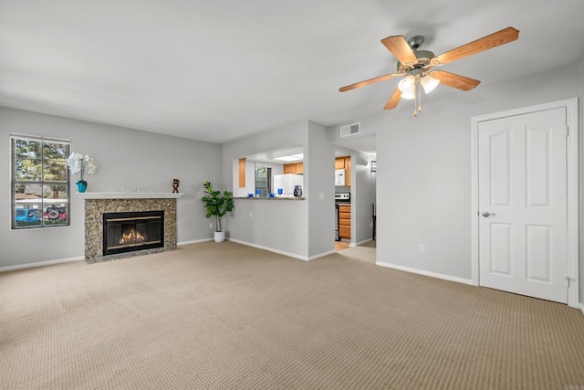 15032 Avenida Venusto Unit 179, San Diego, CA 92128 - unfurnished living room with light colored carpet, a fireplace, and a ceiling fan