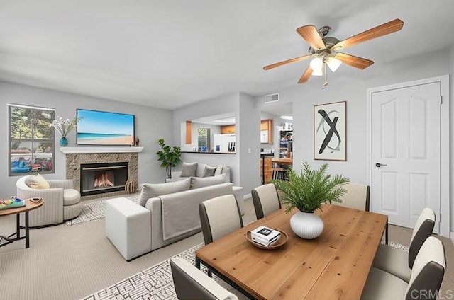 15032 Avenida Venusto Unit 179, San Diego, CA 92128 - dining area featuring light colored carpet, a glass covered fireplace, and a ceiling fan