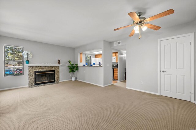 15032 Avenida Venusto Unit 179, San Diego, CA 92128 - unfurnished living room featuring light carpet, a fireplace, and ceiling fan