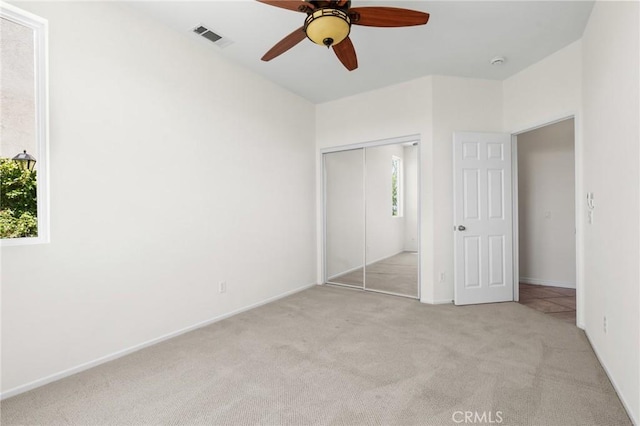 24058 Via Vis, Valencia, CA 91354 - unfurnished bedroom featuring multiple windows, light colored carpet, a closet, and ceiling fan