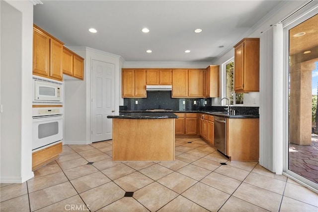 24058 Via Vis, Valencia, CA 91354 - kitchen featuring white appliances, a kitchen island, under cabinet range hood, light tile patterned floors, and backsplash