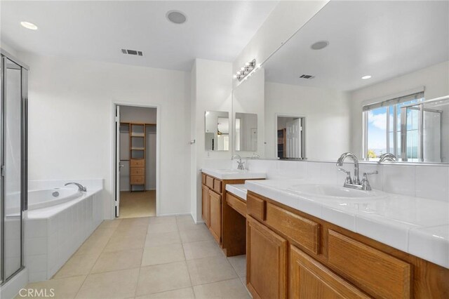 24058 Via Vis, Valencia, CA 91354 - bathroom with vanity, a garden tub, a shower stall, tile patterned floors, and recessed lighting