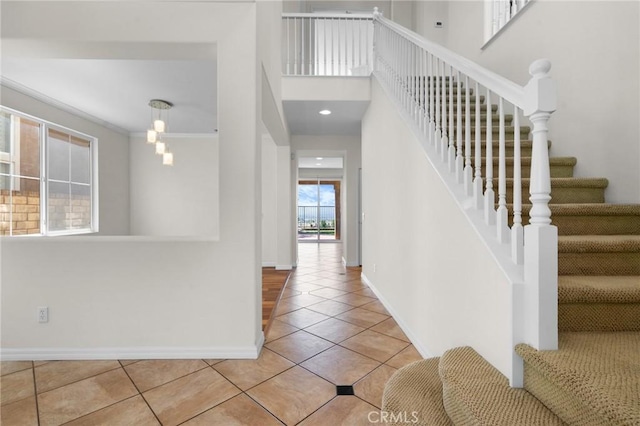 24058 Via Vis, Valencia, CA 91354 - entryway with tile patterned flooring, stairs, and ornamental molding