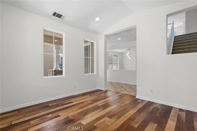 24058 Via Vis, Valencia, CA 91354 - spare room featuring wood-type flooring and vaulted ceiling