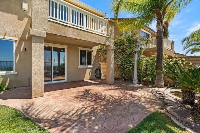 24058 Via Vis, Valencia, CA 91354 - back of property featuring a balcony, stucco siding, and a patio