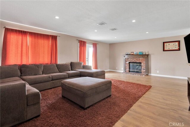 8960 Buckthorn Ave, Hesperia, CA 92345 - living room featuring wood finished floors, recessed lighting, and a fireplace