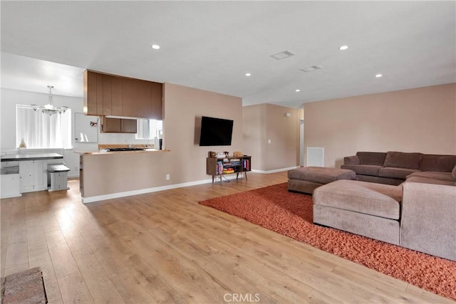 8960 Buckthorn Ave, Hesperia, CA 92345 - living room with a chandelier, light wood finished floors, and recessed lighting
