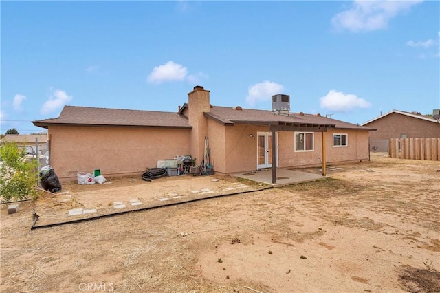 8960 Buckthorn Ave, Hesperia, CA 92345 - rear view of house featuring french doors, a patio area, stucco siding, and a chimney