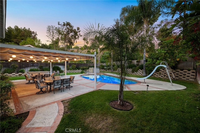 1722 Calle Alto, San Dimas, CA 91773 - pool at dusk featuring a fenced backyard, a patio, and a water slide