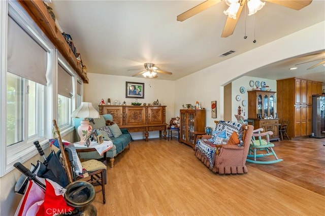1117 Gladstone St, La Verne, CA 91750 - living room with ceiling fan, arched walkways, and light wood-style flooring