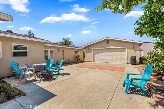 1117 Gladstone St, La Verne, CA 91750 - view of patio with a fire pit, a garage, and concrete driveway