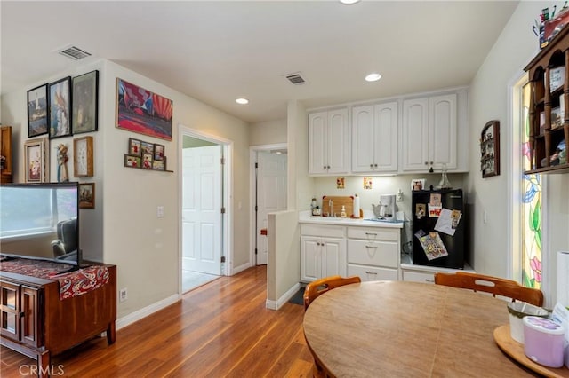 1117 Gladstone St, La Verne, CA 91750 - kitchen with white cabinets, light wood-type flooring, recessed lighting, and light countertops