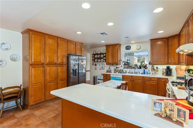 1117 Gladstone St, La Verne, CA 91750 - kitchen with stainless steel refrigerator with ice dispenser, light countertops, brown cabinetry, recessed lighting, and a peninsula