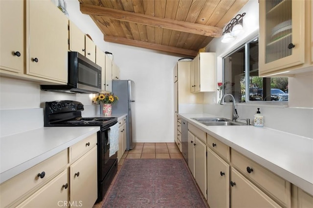 3331 Via Altamira, Fallbrook, CA 92028 - kitchen with appliances with stainless steel finishes, a wood ceiling with exposed beams, light countertops, cream cabinets, and light tile patterned floors