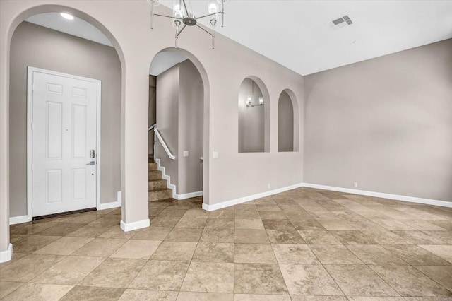 13325 Via Tresca Unit 7, San Diego, CA 92129 - unfurnished room featuring a chandelier, stairs, arched walkways, and light tile patterned flooring