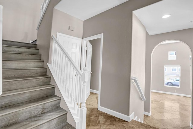 13325 Via Tresca Unit 7, San Diego, CA 92129 - staircase with arched walkways and tile patterned flooring
