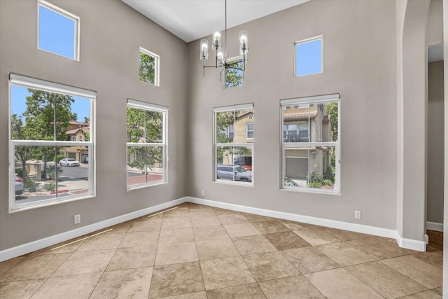 13325 Via Tresca Unit 7, San Diego, CA 92129 - tiled empty room with plenty of natural light, a chandelier, and a towering ceiling