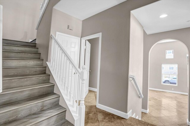 13325 Via Tresca Unit 7, San Diego, CA 92129 - stairs with arched walkways and tile patterned flooring