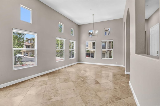 13325 Via Tresca Unit 7, San Diego, CA 92129 - unfurnished dining area featuring a chandelier and a high ceiling