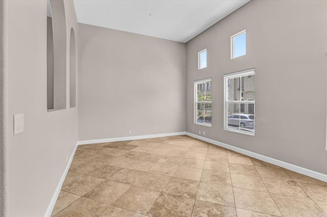 13325 Via Tresca Unit 7, San Diego, CA 92129 - unfurnished room with baseboards and a towering ceiling