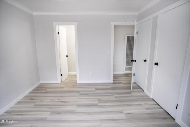 1925 Ginger St Unit 112, Oxnard, CA 93036 - unfurnished bedroom with a heating unit, crown molding, and light wood-style floors