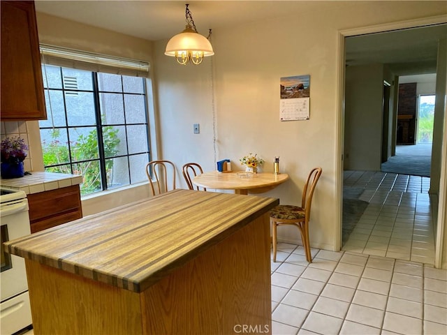 28432 Alava, Mission Viejo, CA 92692 - kitchen featuring electric range, light tile patterned floors, decorative light fixtures, tile countertops, and decorative backsplash