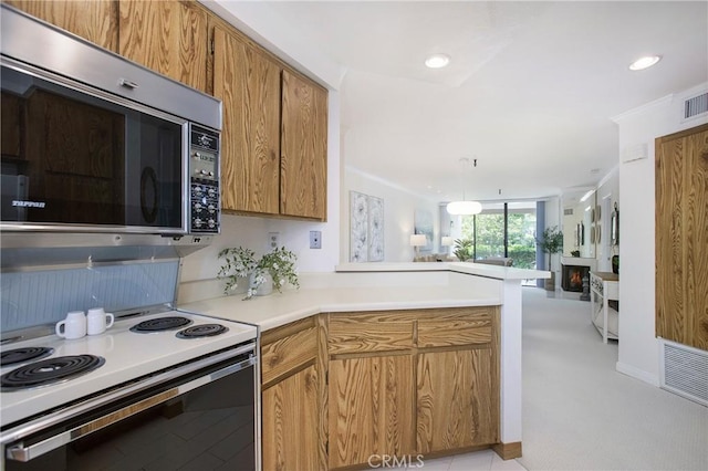 26701 Quail Crk Unit 31, Laguna Hills, CA 92656 - kitchen featuring stainless steel microwave, a peninsula, open floor plan, electric stove, and brown cabinetry