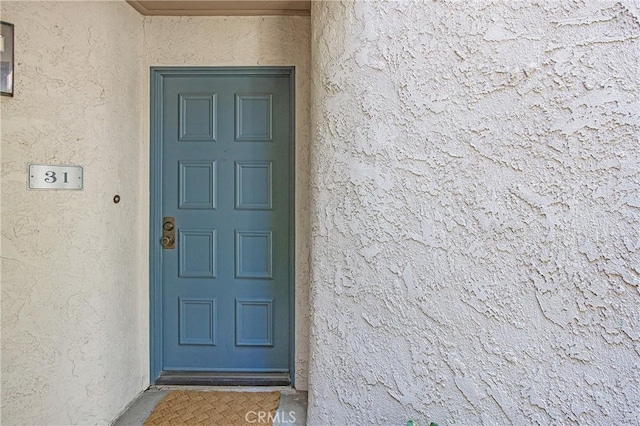 26701 Quail Crk Unit 31, Laguna Hills, CA 92656 - view of exterior entry with stucco siding