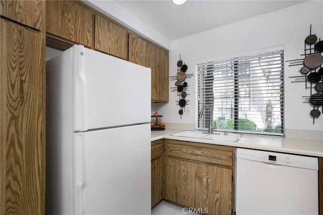 26701 Quail Crk Unit 31, Laguna Hills, CA 92656 - kitchen featuring white appliances, brown cabinets, and light countertops