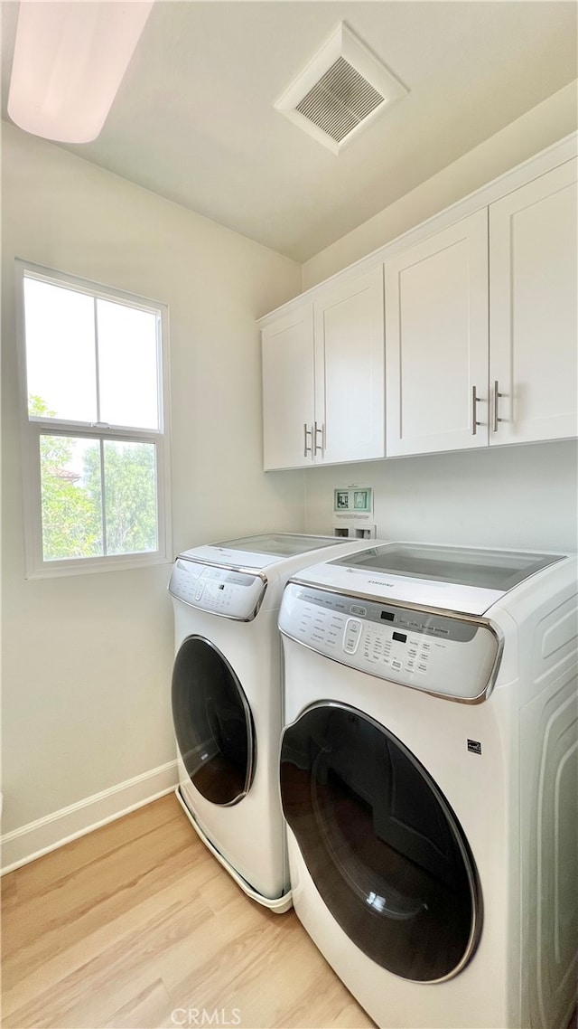122 Espina, Irvine, CA 92620 - laundry room with cabinet space, washer and dryer, and light wood-style flooring