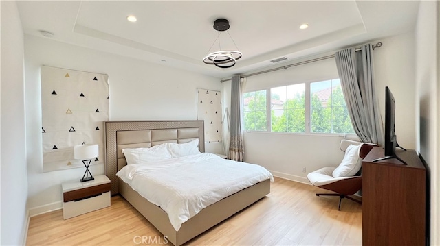122 Espina, Irvine, CA 92620 - bedroom featuring a tray ceiling, light wood-style flooring, and recessed lighting