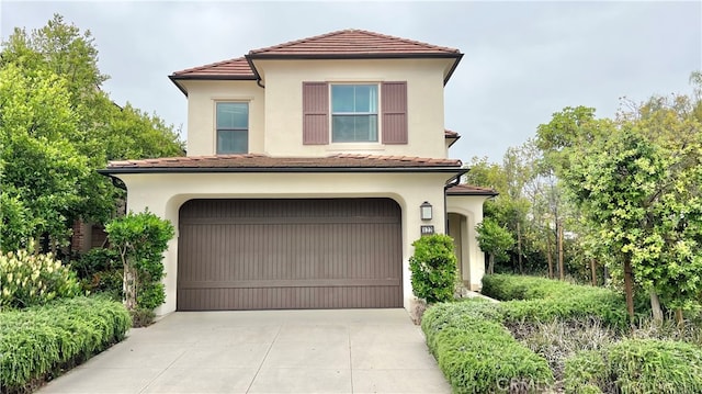 122 Espina, Irvine, CA 92620 - mediterranean / spanish home with a garage, driveway, a tile roof, and stucco siding