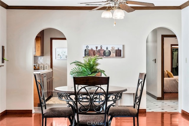 520 W Santa Clara Ave, Santa Ana, CA 92706 - dining area with ceiling fan, crown molding, arched walkways, and wood finished floors