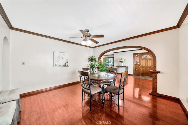 520 W Santa Clara Ave, Santa Ana, CA 92706 - dining area featuring arched walkways, ceiling fan, hardwood / wood-style floors, and crown molding