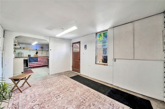 520 W Santa Clara Ave, Santa Ana, CA 92706 - foyer entrance with unfinished concrete floors and arched walkways