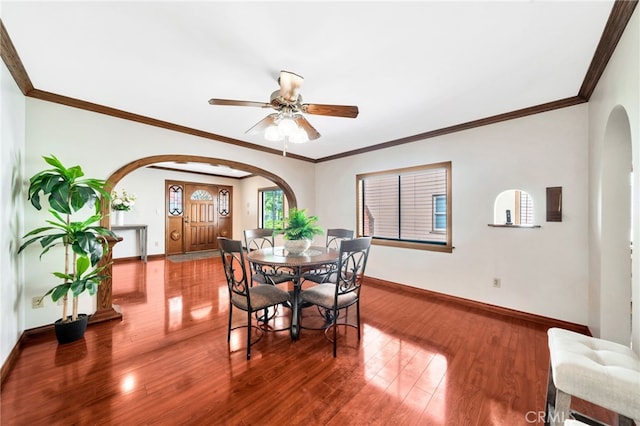 520 W Santa Clara Ave, Santa Ana, CA 92706 - dining room with arched walkways, wood finished floors, a ceiling fan, and crown molding
