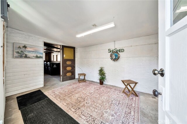 520 W Santa Clara Ave, Santa Ana, CA 92706 - hallway with unfinished concrete flooring and wooden walls