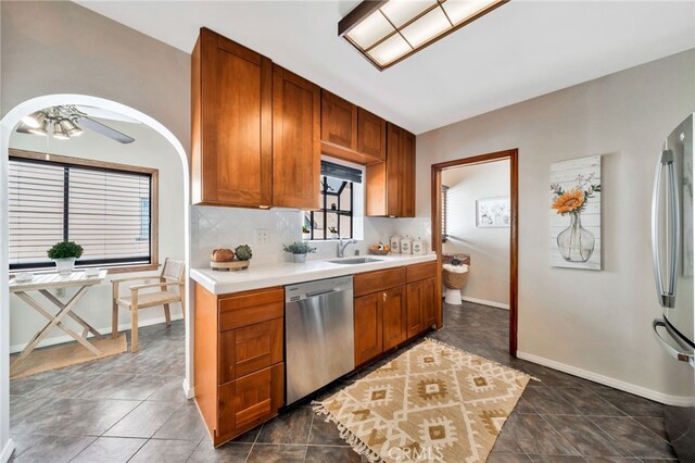 520 W Santa Clara Ave, Santa Ana, CA 92706 - kitchen with appliances with stainless steel finishes, light countertops, backsplash, and brown cabinets