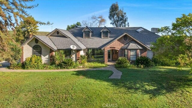 6710 Golden State Blvd, Madera, CA 93637 - view of front of home featuring a front yard and brick siding