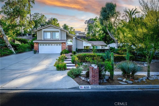 6255 Barranca Dr, Riverside, CA 92506 - view of front of house featuring a garage, concrete driveway, and brick siding