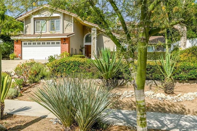 6255 Barranca Dr, Riverside, CA 92506 - view of front of house with brick siding, a garage, and driveway