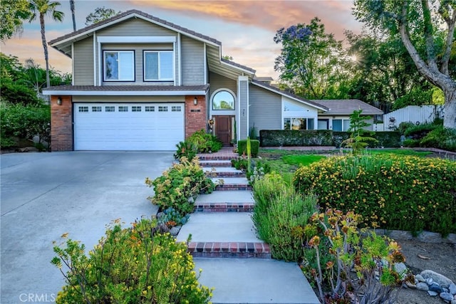 6255 Barranca Dr, Riverside, CA 92506 - view of front of property with a garage, driveway, and brick siding
