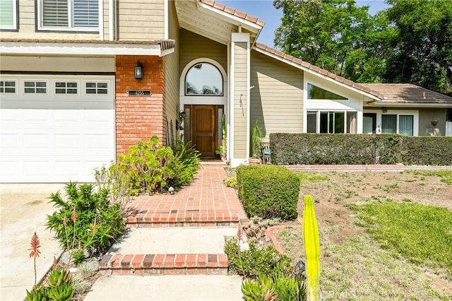 6255 Barranca Dr, Riverside, CA 92506 - property entrance with brick siding, a garage, and driveway