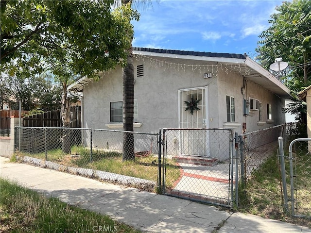 541 W F St, Colton, CA 92324 - view of property exterior featuring a gate, stucco siding, and a fenced front yard