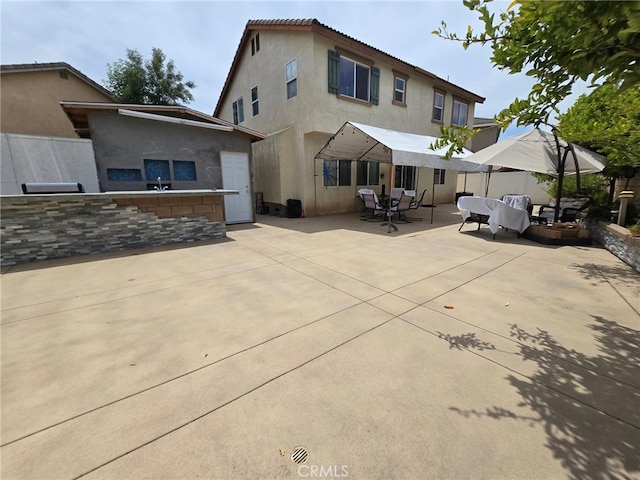 1315 Plaza Way, Perris, CA 92570 - back of house featuring stucco siding, a patio, and outdoor dining area