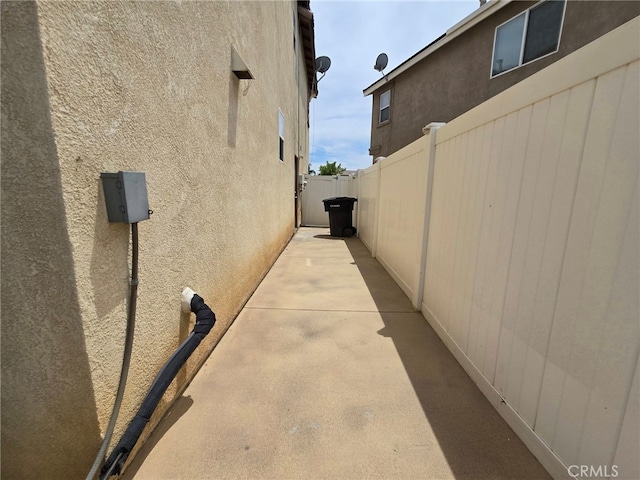 1315 Plaza Way, Perris, CA 92570 - view of side of property with stucco siding and a patio area