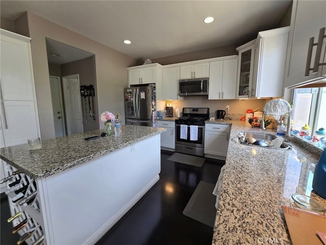 1315 Plaza Way, Perris, CA 92570 - kitchen featuring appliances with stainless steel finishes, a center island, light stone countertops, white cabinetry, and recessed lighting